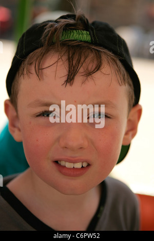 Young Boy, wearing baseball hat backwards, Stock Photo