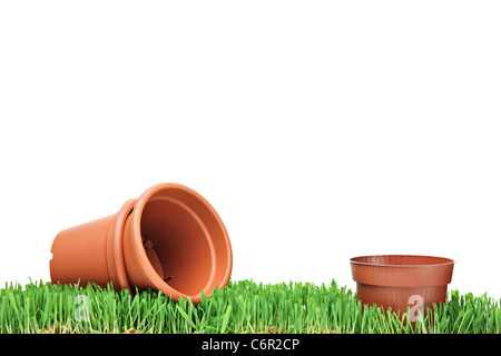 A studio shot of empty flower pots on a green grass Stock Photo