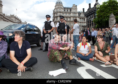 Democracy Village campers hold a peaceful sit-down protest outside the Houses of Parliament. Stock Photo