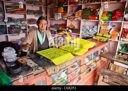 Elderly woman manufacturing payer flags in Tawang, Arunachal Pradesh, India Stock Photo