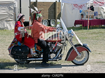 Grand Marshall of the parade held during the annual Shoshone-Bannock Festival with a passenger on an Indian brand motorcycle. Stock Photo