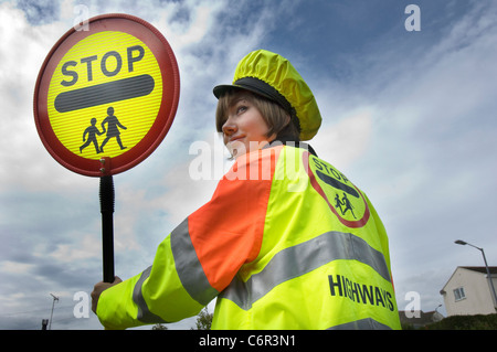 Pretty smiling teenage lollipop lady on school crossing patrol duty in rural Cornwall Stock Photo