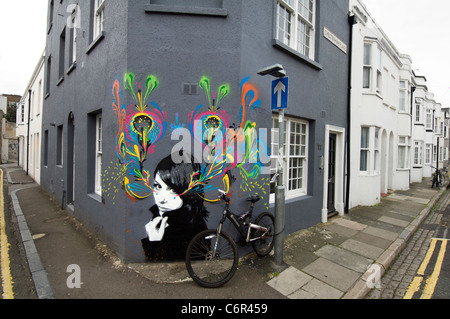 Graffiti of a girl by Hutch and Stinkfish spray painted on a terrace house in North Laine, Brighton, East Sussex, UK Stock Photo