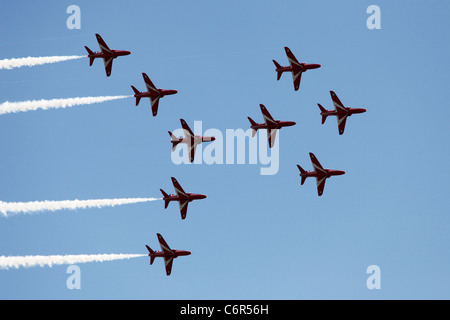 'Red Arrows' Hawk T1 jets flying in Viggen formation against blue sky, England, UK Stock Photo