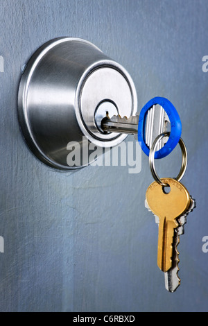 Keys inserted in door lock close up Stock Photo