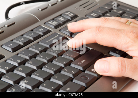 hand pressing enter on keyboard Stock Photo