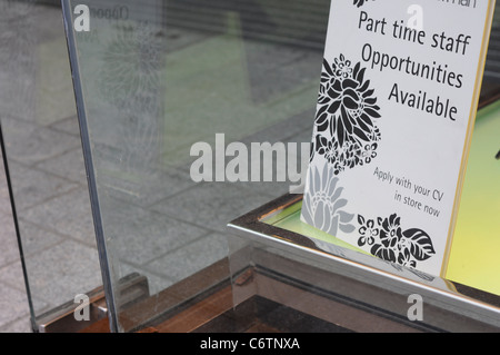 Staff vacancies help wanted sign in a shop window. Stock Photo