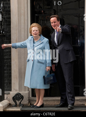Margaret Thatcher, David Cameron Former British Conservative Prime Minster Baroness Thatcher being greeted, on the door step of Stock Photo