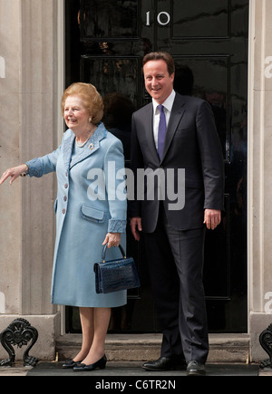 Margaret Thatcher, David Cameron Former British Conservative Prime Minster Baroness Thatcher being greeted, on the door step of Stock Photo