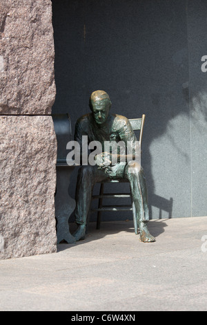 Distant telephoto shot of the statue in Roosevelt memorial of a poor hungry man listening to a fireside chat on the radio in Washington DC Stock Photo
