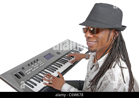 Musician wearing a hat and sunglasses as he plays an electronic keyboard Stock Photo