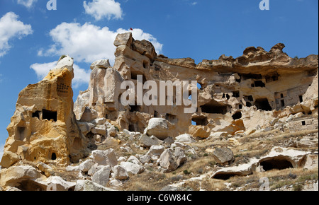 relics and ruins of an old cave village habitat of humans carved from limestone and sandstone hills, landscape, blue sky clouds