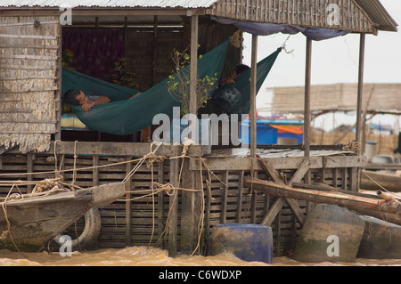 Man in a hammock at Kompong Klang floating village, Tonle Sap lake, near Siem Reap, Cambodia Stock Photo