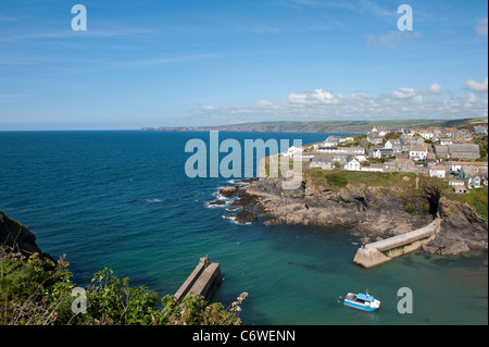 Small boat entering the pretty harbour of Port Issac in Cornwall, England. Stock Photo