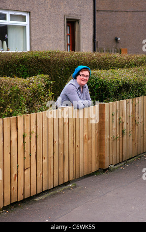 Susan Boyle in high spirits while happily chatting to photographers outside her house, wearing a blue hat and striped shirt. Stock Photo