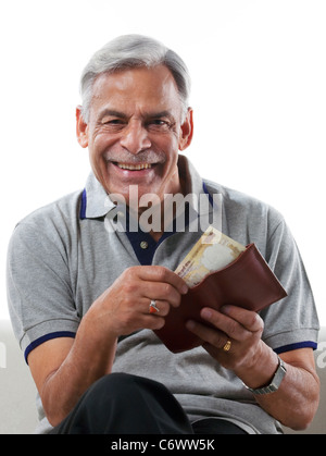 Old man taking money out of a wallet Stock Photo