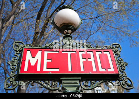 Paris metro sign with trees and sky background. Stock Photo