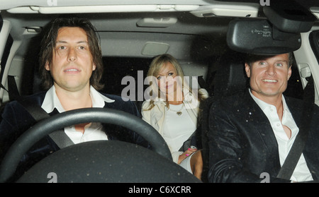 Amanda Holden with husband Chris Hughes (left) and British racing driver, David Coulthard, leaving a restaurant in Mayfair Stock Photo