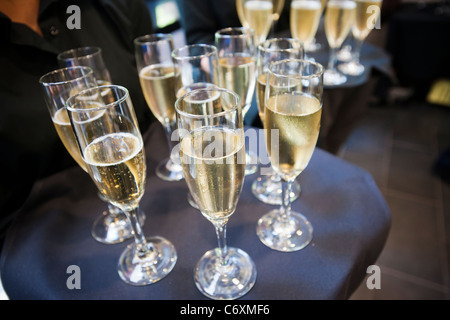 A waitperson serves champagne to guests at the opening of a restaurant in New York Stock Photo