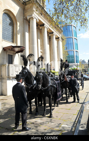 A horse drawn carriage carries the coffin containing the body of the late Malcolm McLaren who died of mesothelioma on April Stock Photo
