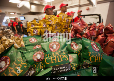 Employees wait to greet hungry customers at the Earl of Sandwich opening of their first shop in New York Stock Photo