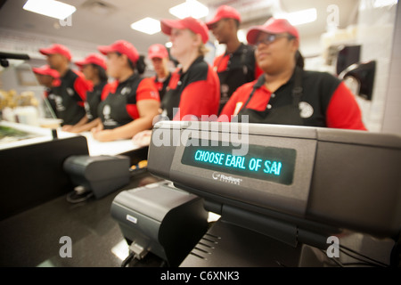 Employees wait to greet hungry customers at the Earl of Sandwich opening of their first shop in New York Stock Photo