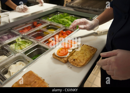 Workers prepare sandwiches at the Earl of Sandwich opening of their first shop in New York Stock Photo