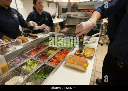 Workers prepare sandwiches at the Earl of Sandwich opening of their first shop in New York Stock Photo