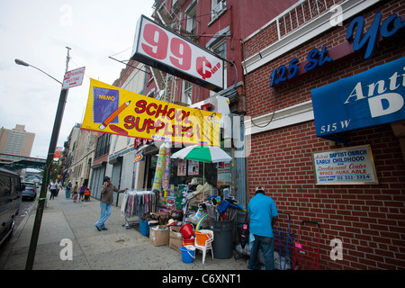 Back to school specials are advertised outside a 99 cent store on 125th Street in the Harlem neighborhood of New York Stock Photo