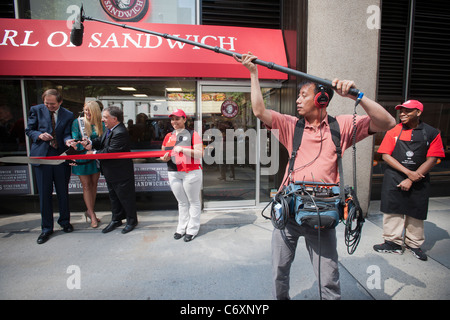 A sound technician records for a video at the opening of an Earl of Sandwich shop in New York Stock Photo