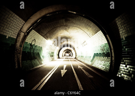 High-contrast exposure of a tunnel with arrows on the street Stock Photo