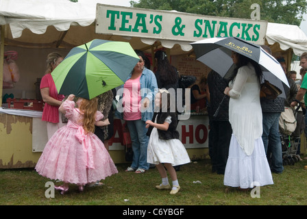 Young gypsy girls in their best clothes with parents and grandmother. Barnet Gypsy Horse Fair Hertfordshire UK. 2011 2010s. In 1588 Queen Elizabeth I granted Bartnet a Royal charter to hold a Fair. HOMER SYKES Stock Photo