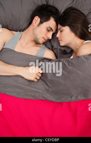 Couple asleep in bed together Stock Photo