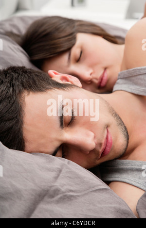 Couple asleep in bed together Stock Photo