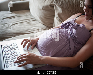 Pregnant woman using laptop Stock Photo