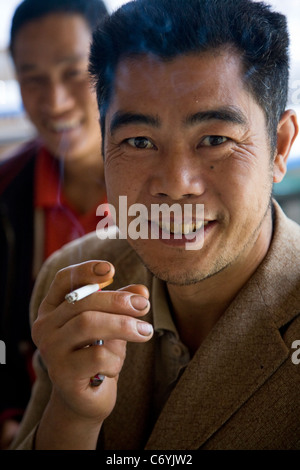 Chinese smoker / man smoking / smokes a cigarette in Sichuan Province, China. Stock Photo