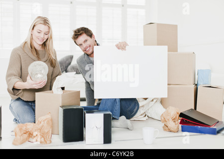Couple unpacking boxes in new home Stock Photo