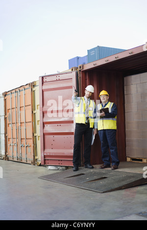 Workers talking in shipping yard