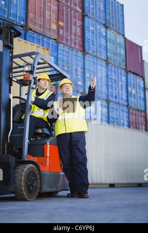 Workers talking in shipping yard Stock Photo