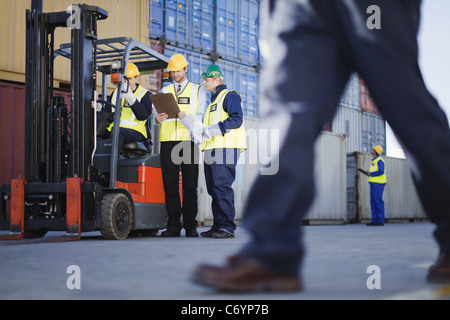 Workers talking in shipping yard