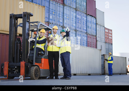 Workers talking in shipping yard Stock Photo