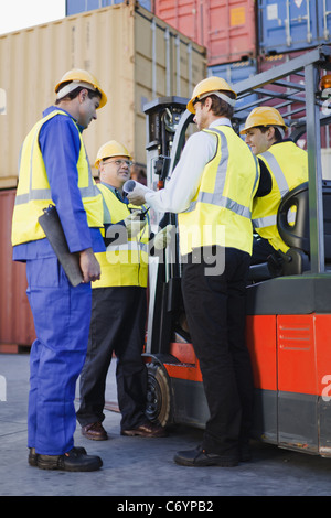 Workers talking in shipping yard
