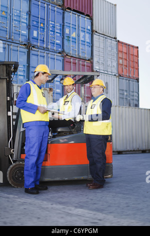Workers talking in shipping yard