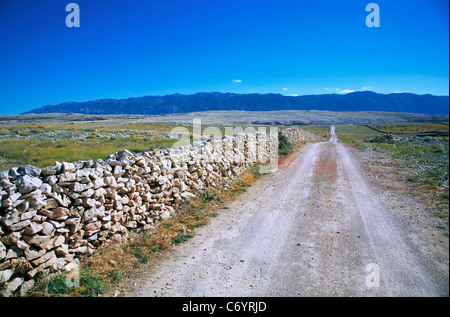 Sandy road from the main road leading to the beach called Zrće on the island of Pag Stock Photo