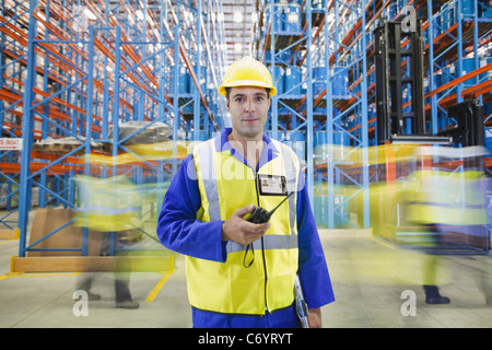 Time lapse view of workers in warehouse Stock Photo