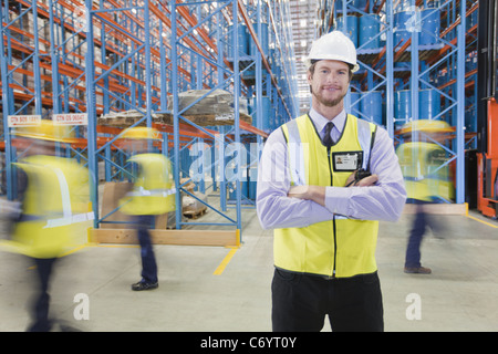 Time lapse view of workers in warehouse Stock Photo