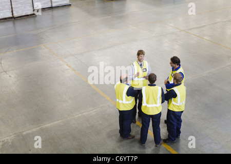 Workers talking in warehouse Stock Photo