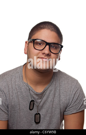 A young teenage man isolated over white wearing black frame nerd glasses and military style dog tags. Stock Photo