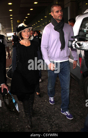 Dannii Minogue and her partner Kris Smith arrive at Heathrow Airport London, England - 12.04.10 Stock Photo