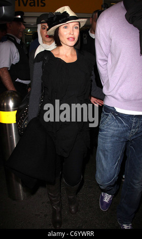 Dannii Minogue and her partner Kris Smith arrive at Heathrow Airport London, England - 12.04.10 Stock Photo